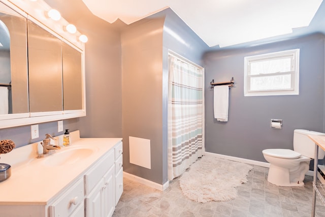 bathroom with vanity, curtained shower, and toilet