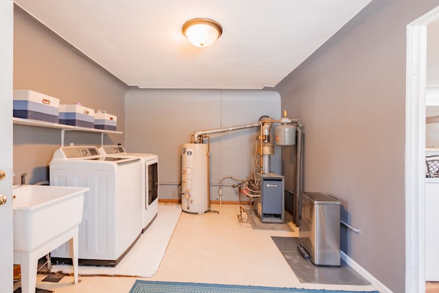 laundry area featuring sink, washer and clothes dryer, and water heater