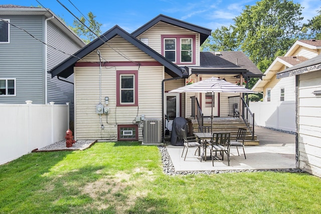 back of house with a yard, a patio area, and central air condition unit