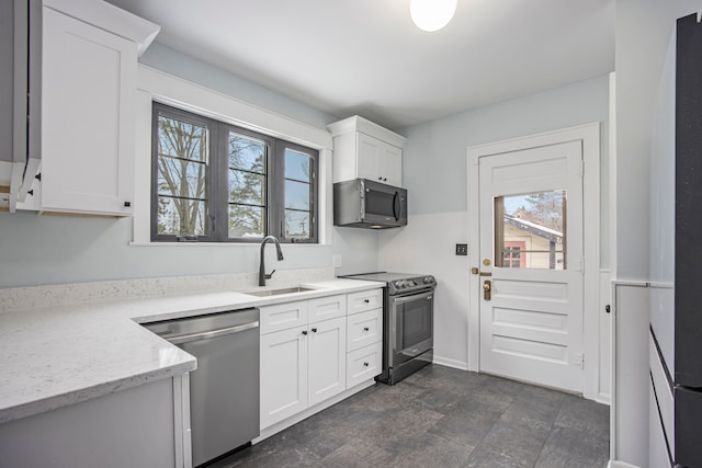 kitchen with stainless steel appliances, sink, and white cabinets