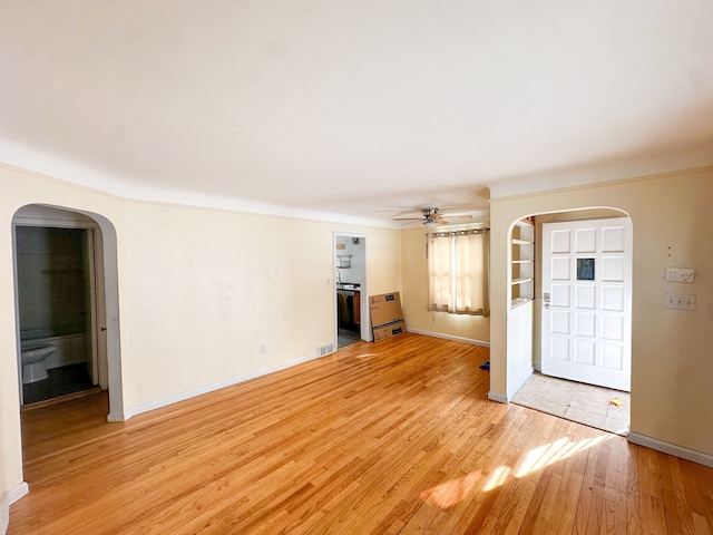 unfurnished living room featuring ceiling fan and light wood-type flooring