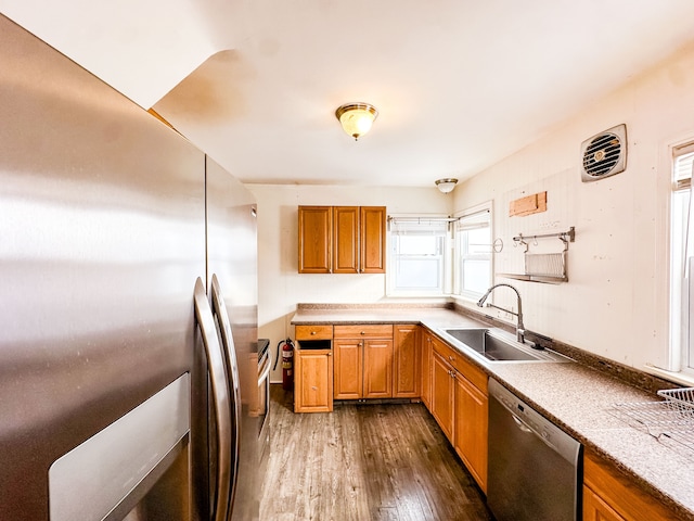 kitchen with stainless steel appliances, sink, and dark wood-type flooring