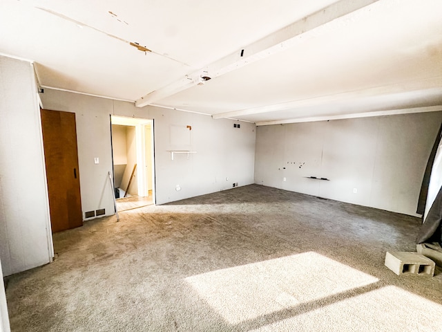 unfurnished room featuring carpet flooring and beam ceiling