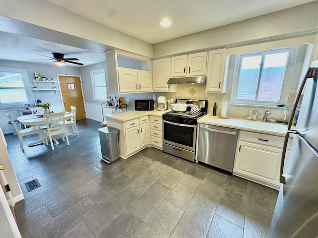 kitchen with white cabinetry, sink, stainless steel appliances, and a healthy amount of sunlight