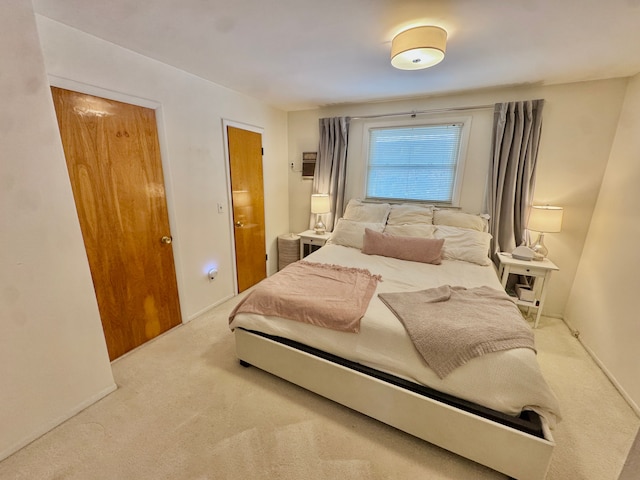 bedroom featuring light colored carpet