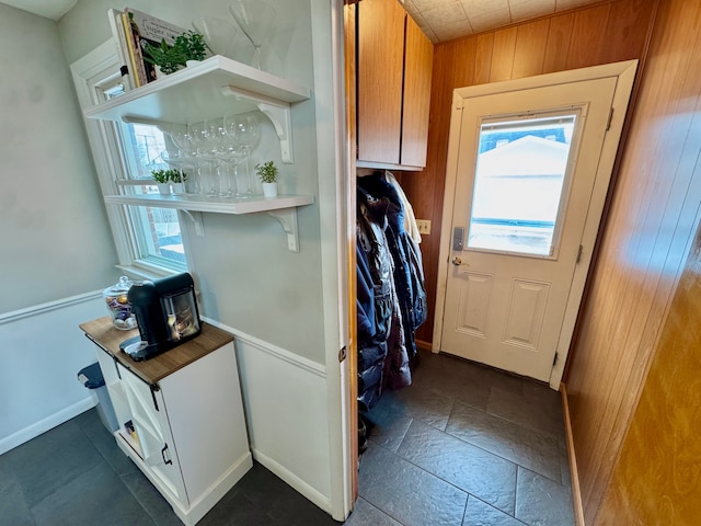 doorway with wood walls