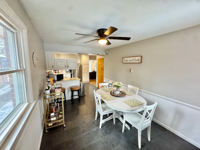 dining space with plenty of natural light and ceiling fan