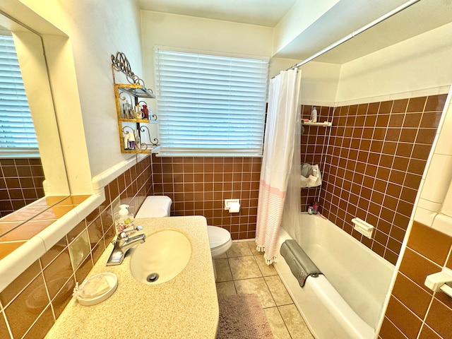 full bathroom featuring sink, shower / bath combo, tile patterned flooring, tile walls, and toilet