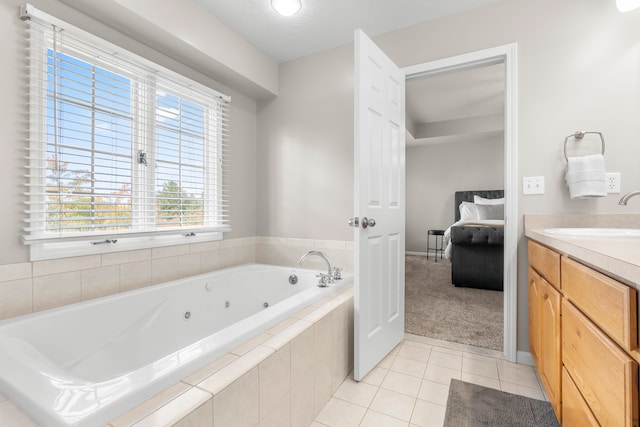 bathroom with vanity, tile patterned floors, and tiled bath