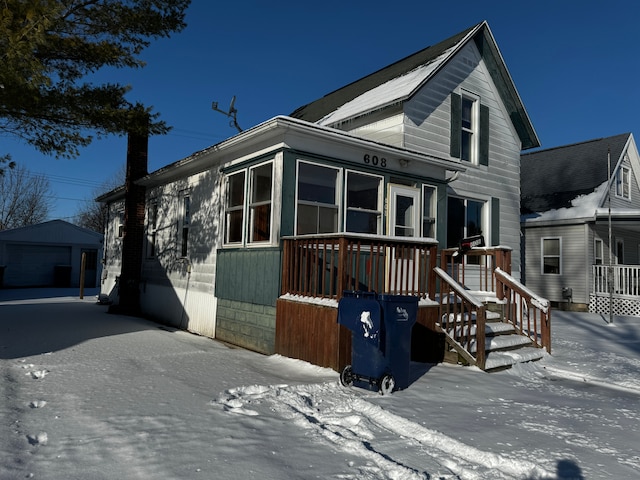 view of front of property with a garage and an outdoor structure