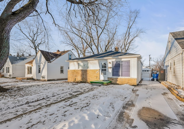 view of snow covered rear of property