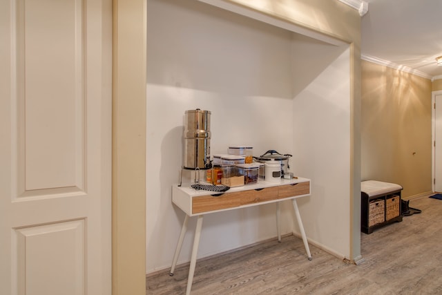 interior space with light hardwood / wood-style flooring and ornamental molding