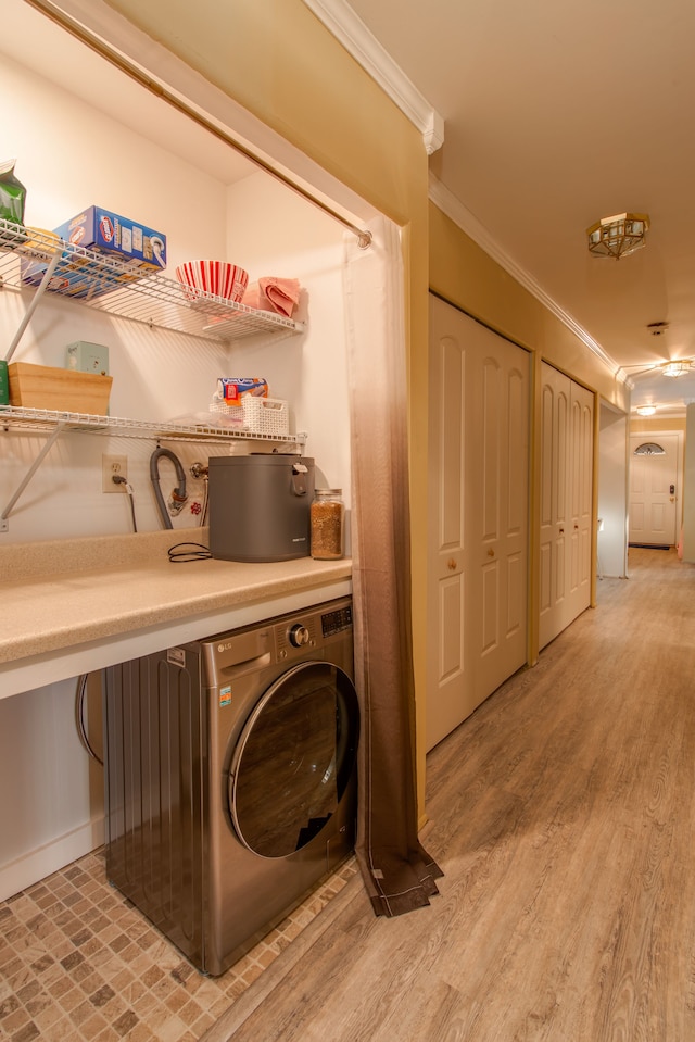 washroom with washer / clothes dryer, wood-type flooring, and ornamental molding