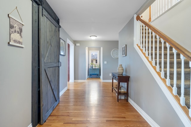 interior space featuring a barn door and light wood-type flooring