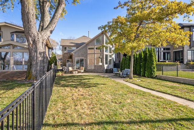 view of front of house featuring a patio area and a front yard