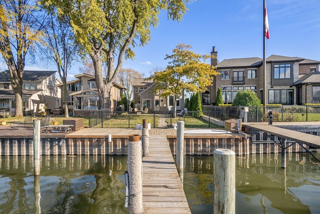 dock area featuring a yard and a water view