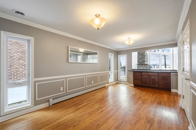 interior space featuring a baseboard radiator, crown molding, and light hardwood / wood-style flooring