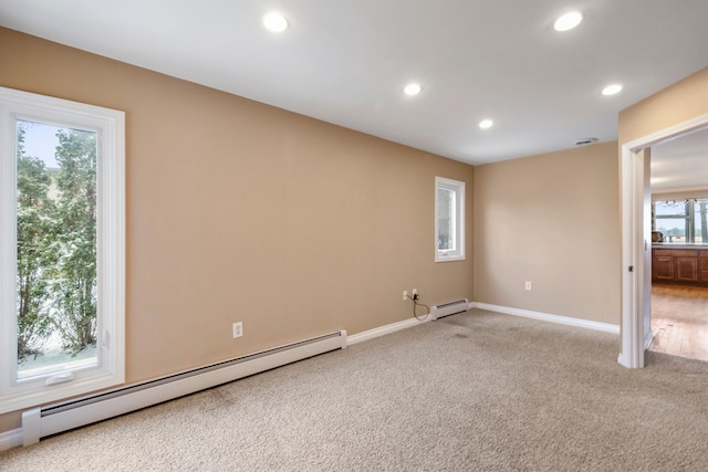 carpeted spare room with baseboard heating