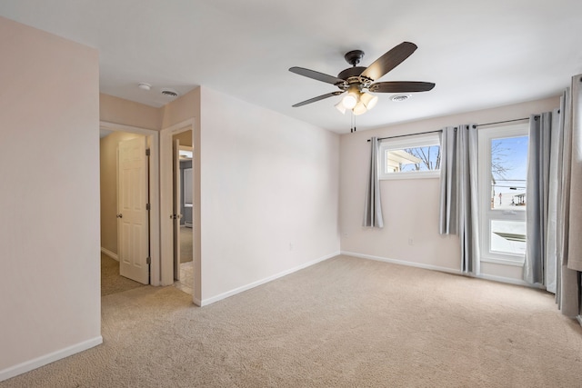 empty room featuring light carpet and ceiling fan