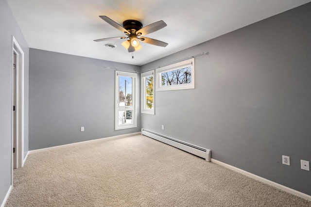 carpeted spare room with a baseboard heating unit and ceiling fan