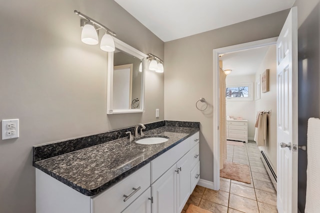 bathroom featuring vanity, tile patterned flooring, and a baseboard heating unit