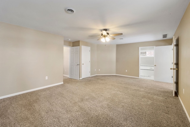 carpeted spare room featuring ceiling fan