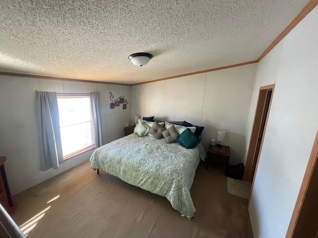 bedroom featuring ornamental molding, a textured ceiling, and carpet