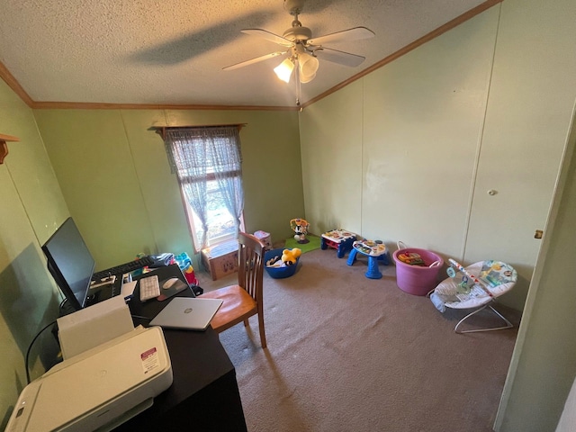 playroom with ceiling fan, ornamental molding, a textured ceiling, and carpet