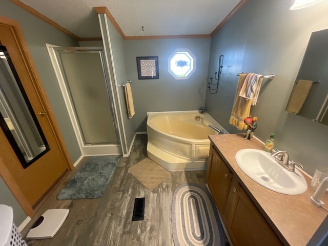 bathroom with hardwood / wood-style flooring, vanity, and independent shower and bath