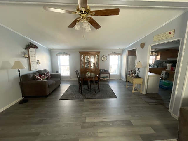 dining space featuring crown molding, lofted ceiling, and dark wood-type flooring