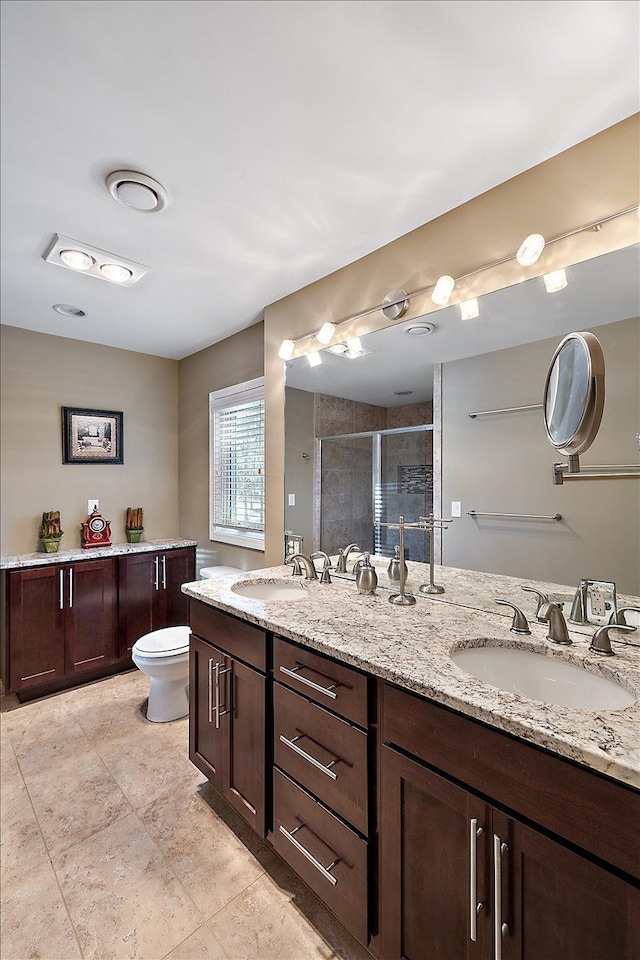 bathroom with vanity, an enclosed shower, and toilet