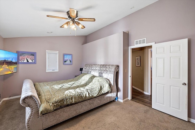 carpeted bedroom with ceiling fan and lofted ceiling