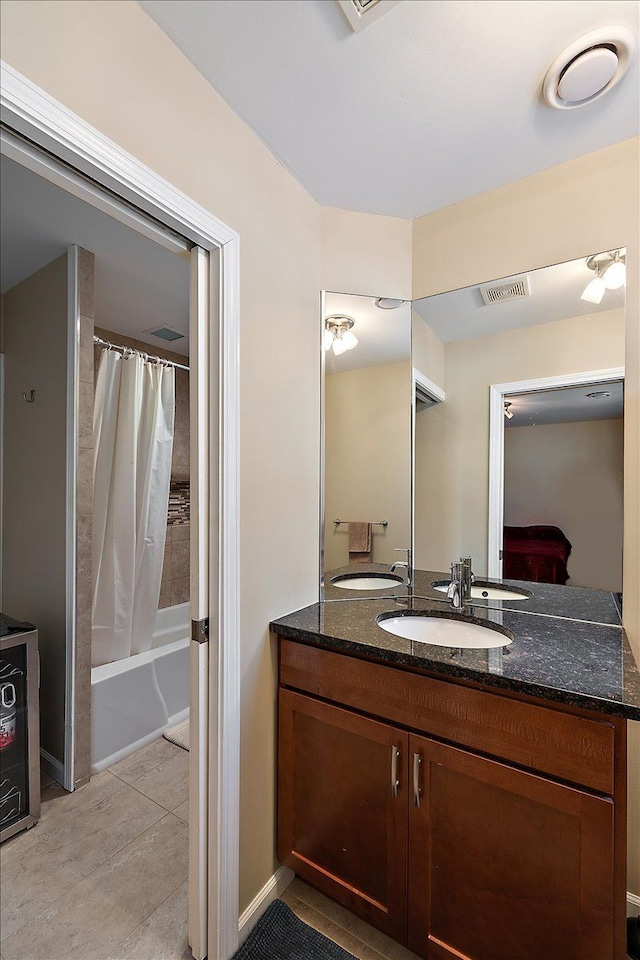 bathroom featuring vanity, tile patterned flooring, and shower / bath combo with shower curtain