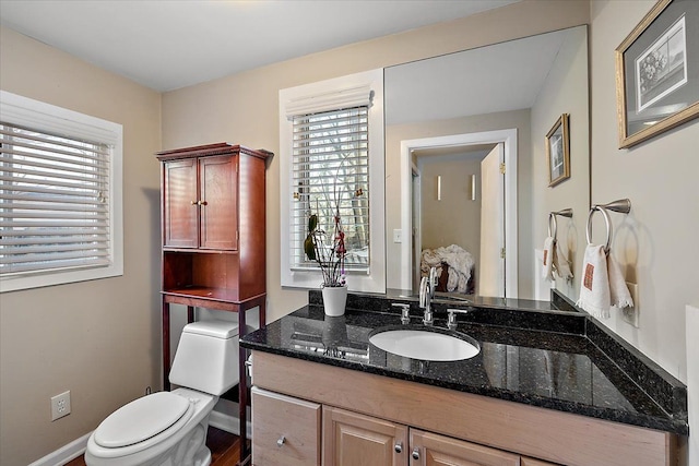 bathroom featuring vanity and toilet