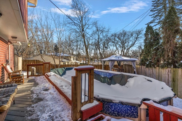 snow covered deck featuring a gazebo and a pool