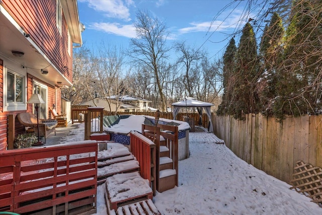 yard layered in snow with a gazebo, an outdoor hangout area, and a deck