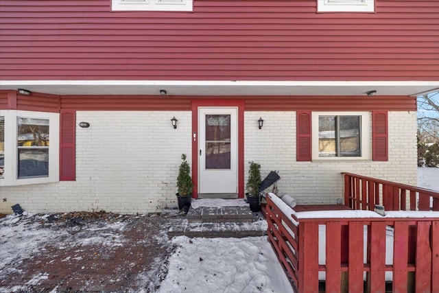 view of snow covered property entrance