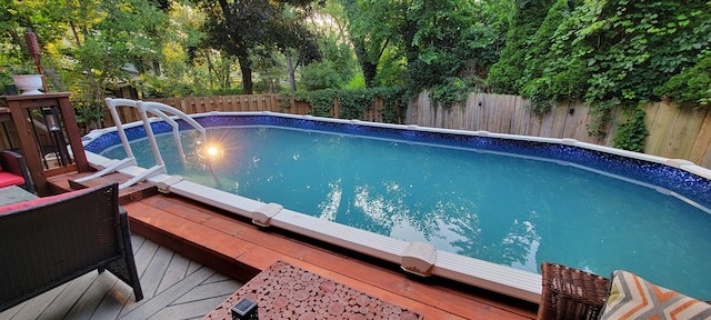 view of swimming pool featuring a wooden deck