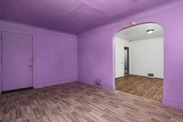 unfurnished room featuring hardwood / wood-style flooring