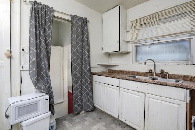 kitchen featuring sink and white cabinets