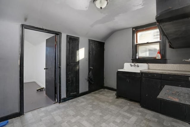 kitchen with lofted ceiling and sink