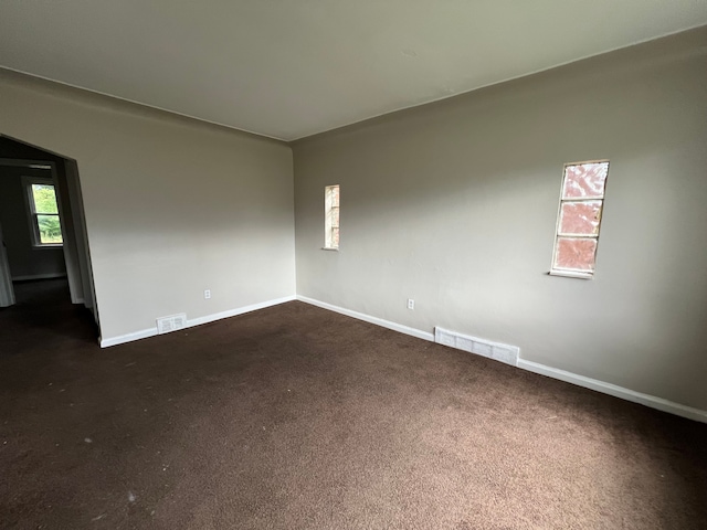 empty room with dark carpet