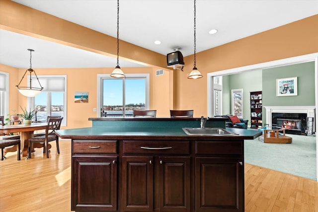 10587 Lighthouse, South Lyon, MI 48178 - kitchen with a sink, open floor plan, light wood-style floors, hanging light fixtures, and recessed lighting