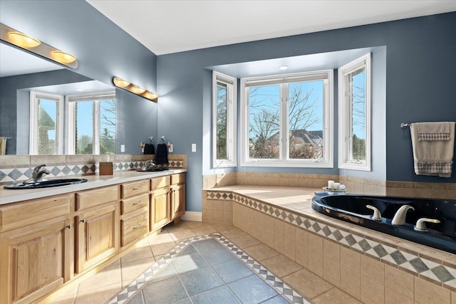 bathroom featuring vanity, tiled tub, tile patterned flooring, and tasteful backsplash