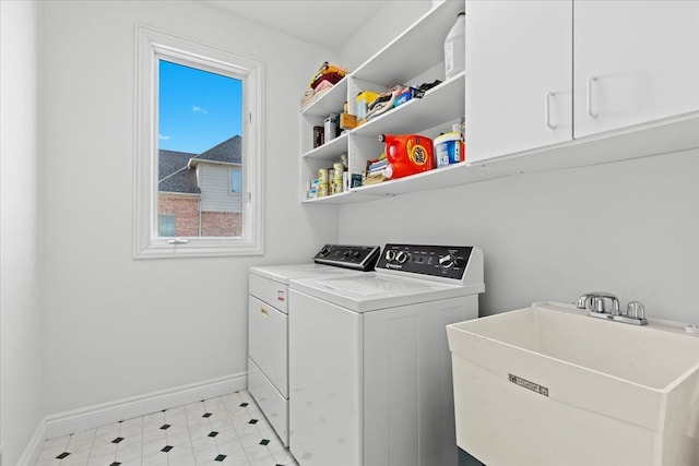 washroom with sink, washer and clothes dryer, and cabinets