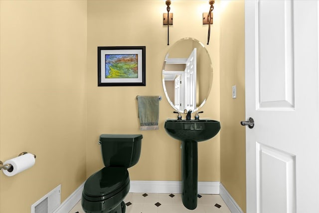 10587 Lighthouse, South Lyon, MI 48178 - bathroom with baseboards, toilet, and tile patterned flooring