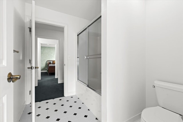 bathroom featuring shower / bath combination with glass door and toilet