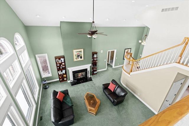 10587 Lighthouse, South Lyon, MI 48178 - living area with high vaulted ceiling, healthy amount of natural light, carpet flooring, baseboards, and recessed lighting