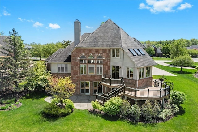 10587 Lighthouse, South Lyon, MI 48178 - rear view of property featuring brick siding, a chimney, a yard, a deck, and a patio