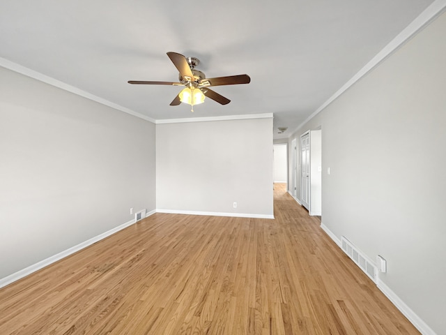 spare room with crown molding, light hardwood / wood-style floors, and ceiling fan